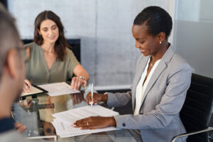 African American woman signing a master development agreement